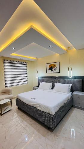 a bedroom with a large bed in a room at Feliza Hotel and Suites in Abeokuta