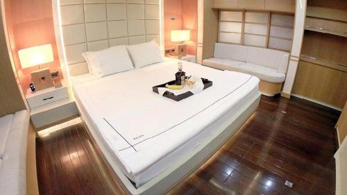 a large white bed in a small room at gold in Fethiye
