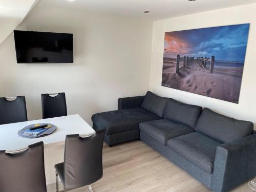 a living room with a couch and a table at Seaside-Amrum-15 in Norddorf