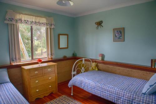Postel nebo postele na pokoji v ubytování Balinga Cottages