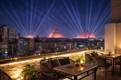 a view of a city at night with lights at TAJ Suites Pyramids View Hotel in Cairo