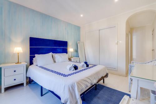 a blue and white bedroom with a large bed at Suites By The River in Ferragudo