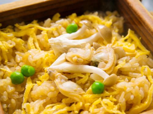 a wooden bowl of rice with peas and cheese at Iseebisou in Ibusuki