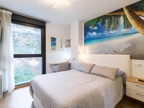 a bedroom with a bed with a painting on the wall at Alojamientos Marte apartamento a pie de playa y garaje in Suances