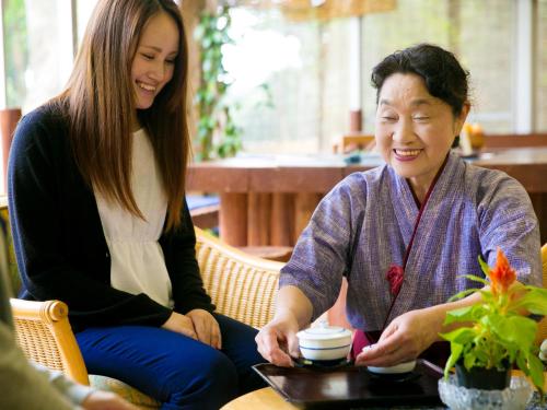 two women sitting next to each other at a table at Iseebisou in Ibusuki