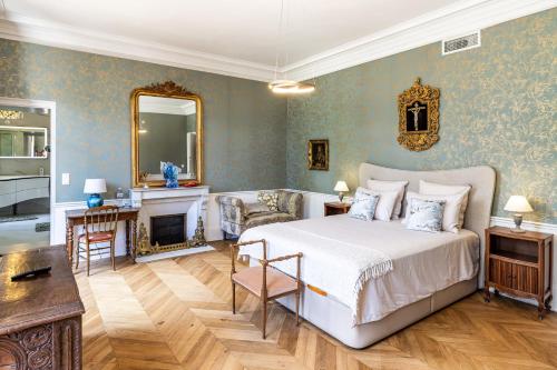 a bedroom with a large bed and a fireplace at château de Puymoger in Javerlhac-et-la-Chapelle-Saint-Robert