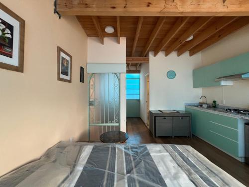 a kitchen with a bed in the middle of a room at Loft en Condesa in Mexico City