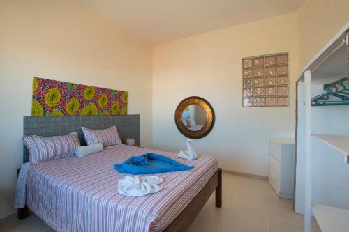 a bedroom with a bed with blue towels on it at aparthotelboavista-net in Sal Rei