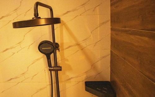 a shower head on a wall in a bathroom at Résidence PLAZZAET OUAGA 2000 in Ouagadougou