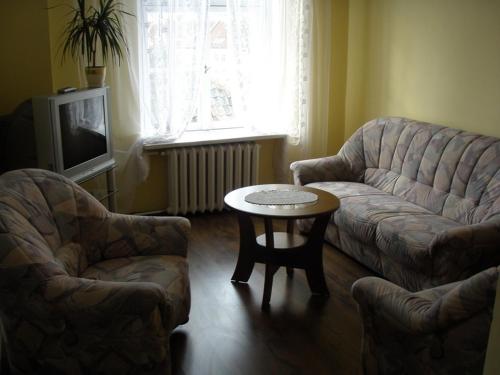 a living room with a couch and a table at SHotels przy Restauracji Stodoła in Bartoszyce