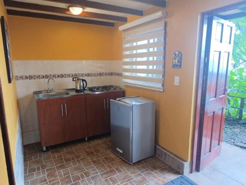 a small kitchen with a sink and a stove at Mirador Finca Morrogacho in Manizales