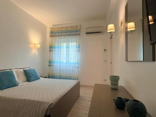 a small bedroom with a bed and a table at Casa Vacanze De Nittis - Meridia Collection in Barletta