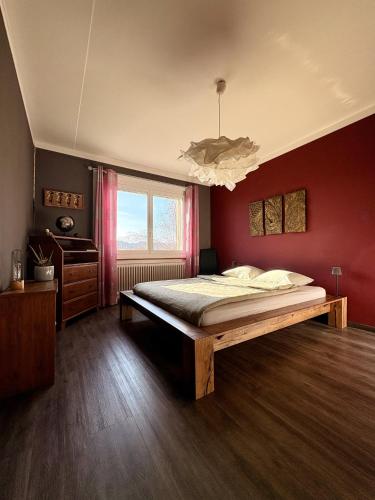 a bedroom with a large bed and a window at Pepper House in La Chaux-de-Fonds