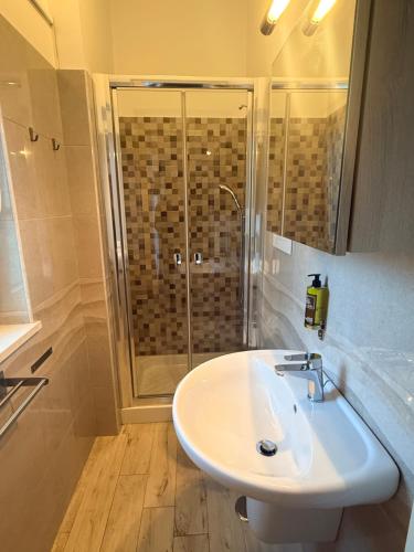 a bathroom with a white sink and a shower at Casa Vacanze De Nittis - Meridia Collection in Barletta