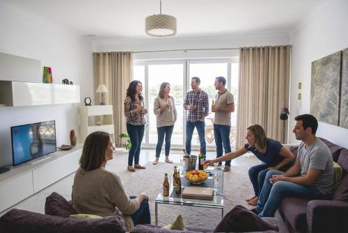 a group of people standing in a living room at The Strand Waterfront Apartment with 3 Bedrooms, 4 Bathrooms, Private Garage in Sliema