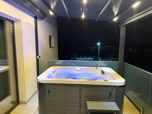 a bath tub in a bathroom with a view of the city at Pensiunea Giulia in Turda