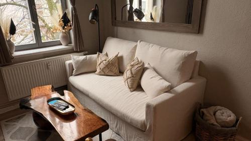 a living room with a white couch and a table at Apartment Baltica in Rostock