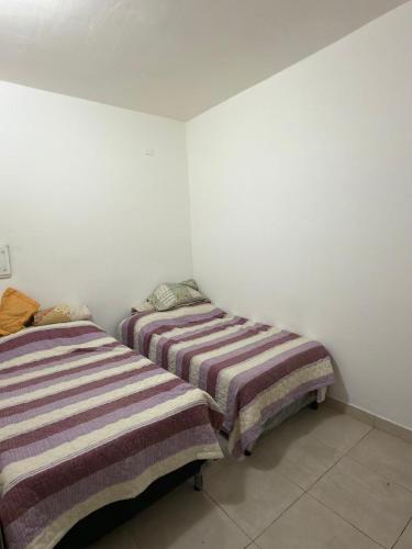 two beds sitting next to each other in a room at Apart Sur Catriel in Catriel