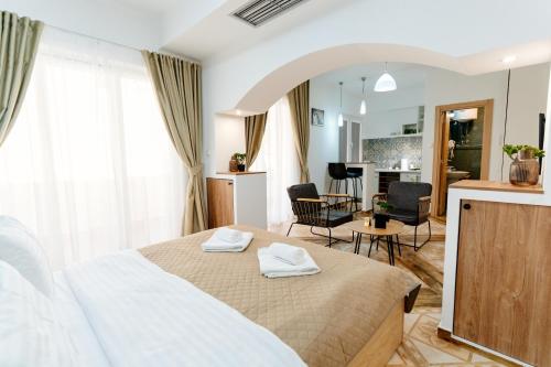 a bedroom with a bed and a living room at Bofima Apartments in Kotor