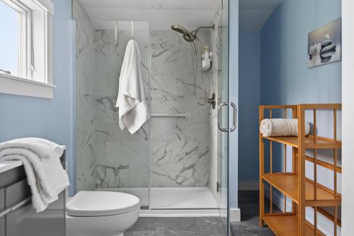 a bathroom with a shower and a toilet at Modern Waterfront Apt with Bay Views in Falmouth