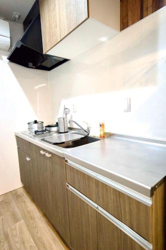 a kitchen with a sink and a counter top at Guest House Re-worth Yabacho1 401 in Nagoya