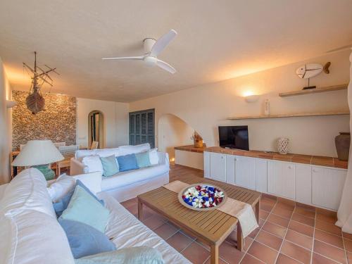 a living room with a couch and a table at Els Tamarells Apartment by 3VILLAS in Fornells