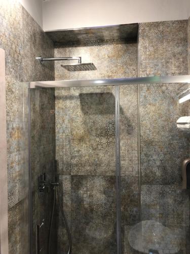 a shower with a glass door in a bathroom at Bed & Breakfast De Nittis - Meridia Collection in Barletta