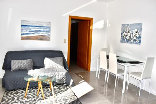 a living room with a couch and a table at Apartmani Cassiopeia in Murine