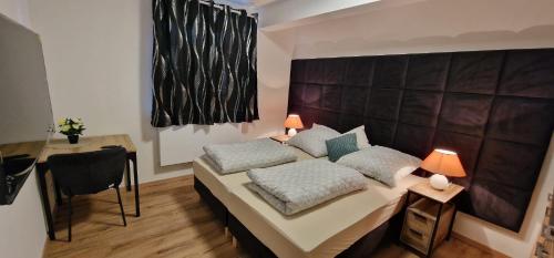 a bedroom with a bed with two pillows on it at Zafibo Gästehaus in Quickborn