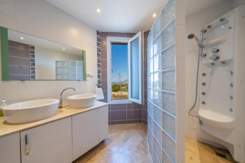 a bathroom with two sinks and a shower at Lacitrus Hotel & Villa in Kaş