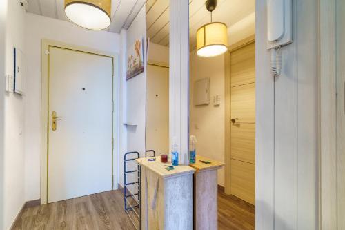a hallway with a table in a room with a door at El Nido in Gavà