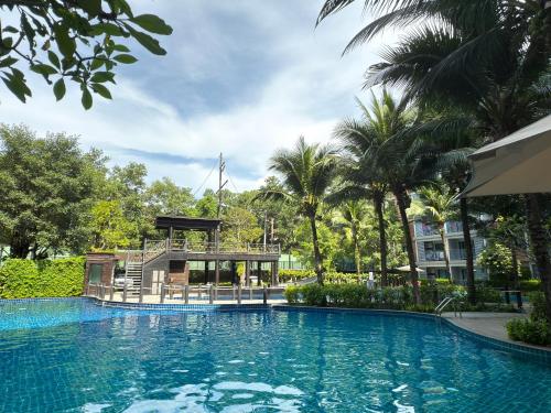 a large swimming pool in front of a building at The Title Residencies Naiyang F by Mill in Nai Yang Beach
