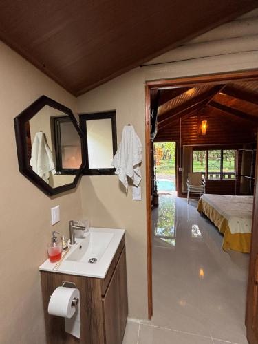a bathroom with a sink and a bed in a room at Nature retreat in Río Cuarto