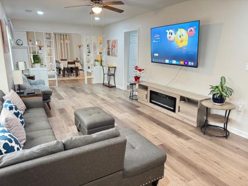 a living room with a couch and a flat screen tv at Brand new spacious and comfort 3-bedroom villa in east central in Memphis