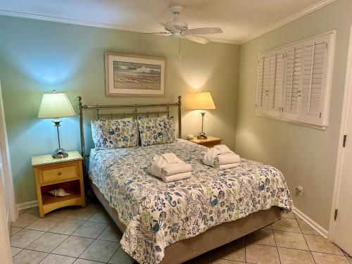 a bedroom with a bed with two towels on it at Seaside 190 in Hilton Head Island