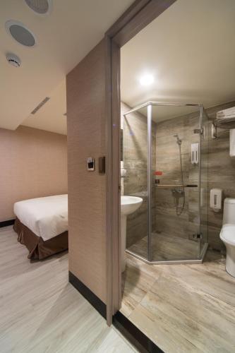 a bathroom with a shower and a toilet and a sink at Hotel Fun - Linsen in Taipei