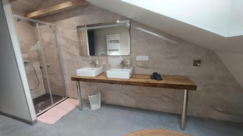 a bathroom with two sinks and a shower at Létable de Boissadel in Boisset