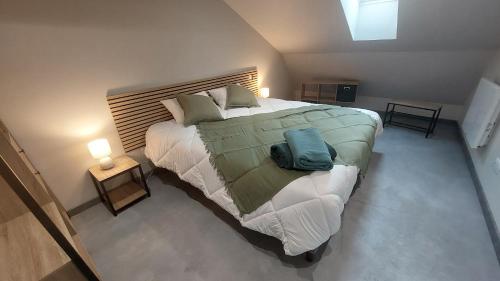 a bedroom with a large bed with a wooden headboard at Létable de Boissadel in Boisset