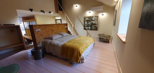 a bedroom with a bed with a yellow blanket at Maison PARAGONE in Bergues