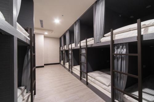 a row of bunk beds in a dorm room at Hotel Fun - Linsen in Taipei