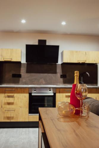 a bottle of wine sitting on a wooden table in a kitchen at Ferienappartment Sickert in Groß Särchen