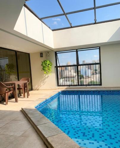 a swimming pool in the middle of a house at Bienal Suítes in São Paulo