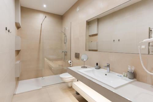 a bathroom with a sink and a toilet and a shower at Littke Pezsgőház in Pécs
