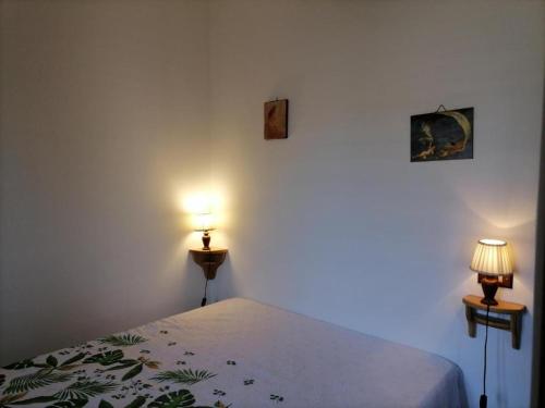 a bedroom with a bed with two lamps on it at Casa Vacanze "Villa Angelina" in Lipari