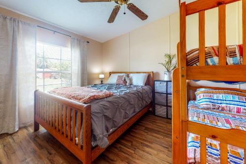 a bedroom with a bunk bed and a ceiling fan at Boat Dock! 'Sunshine House' on St. Johns River in Astor
