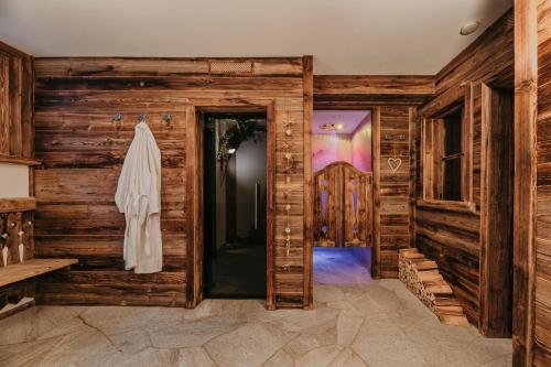 a room with wooden walls and a door at Gutonhof in Selva di Val Gardena