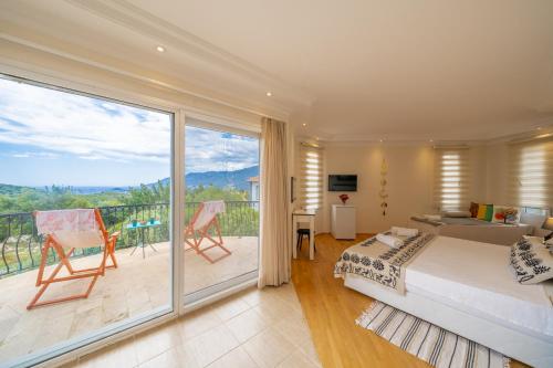 a bedroom with a king sized bed and a balcony at Lacitrus Hotel & Villa in Kaş