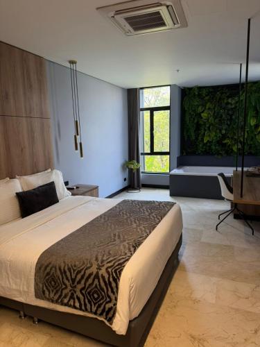 a bedroom with a large bed in a room at Cavalta by Bernalo Hotels in Medellín