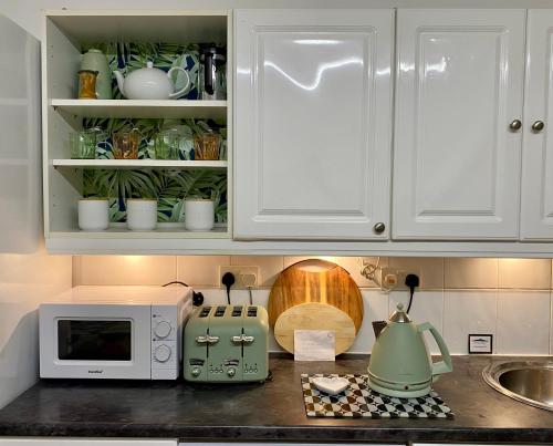 a kitchen counter with a microwave and a toaster oven at Hidden Gem in a great location very near Isle of Skye in Kyle of Lochalsh