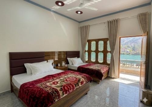 a bedroom with two beds and a window at Skyline Hotel in Uttarkāshi